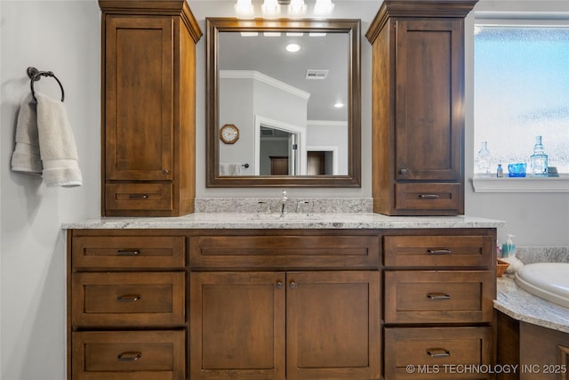 full bathroom featuring vanity, crown molding, and visible vents