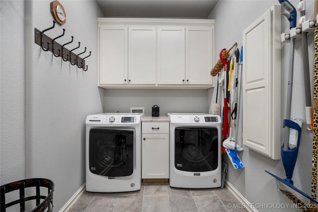 washroom featuring washer hookup, cabinet space, and baseboards