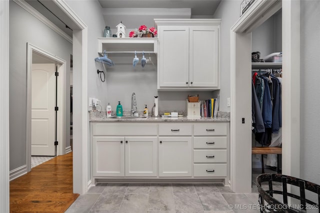 interior space with light wood-style floors and a sink