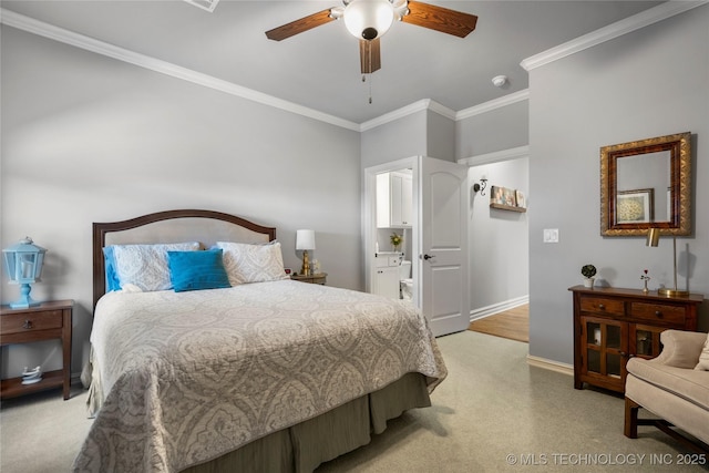 bedroom with connected bathroom, a ceiling fan, baseboards, and ornamental molding