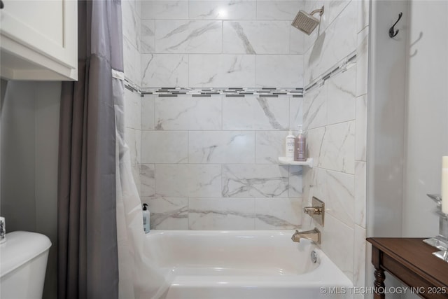 bathroom featuring shower / bath combination with curtain and toilet