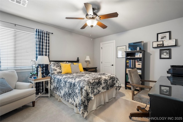 bedroom featuring visible vents, light colored carpet, and a ceiling fan