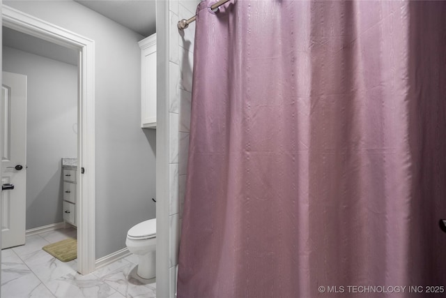 full bathroom featuring vanity, toilet, baseboards, and marble finish floor