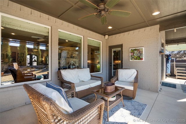 view of patio with an outdoor living space and a ceiling fan