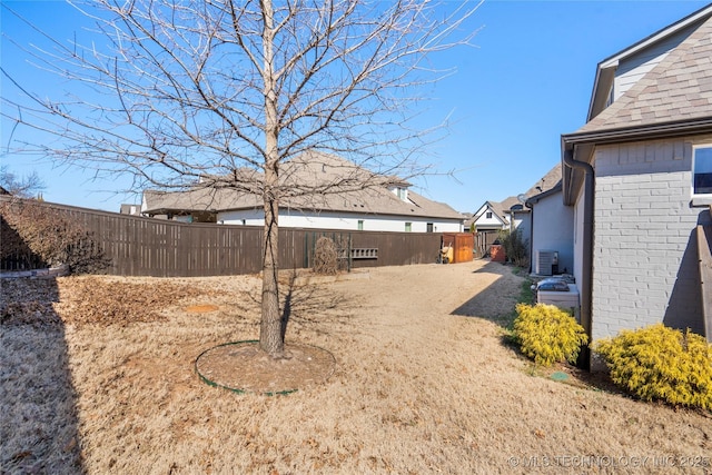 view of yard featuring cooling unit and fence