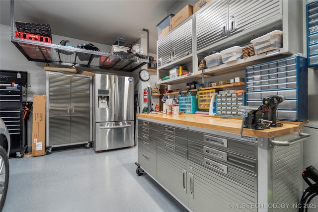 garage featuring stainless steel fridge