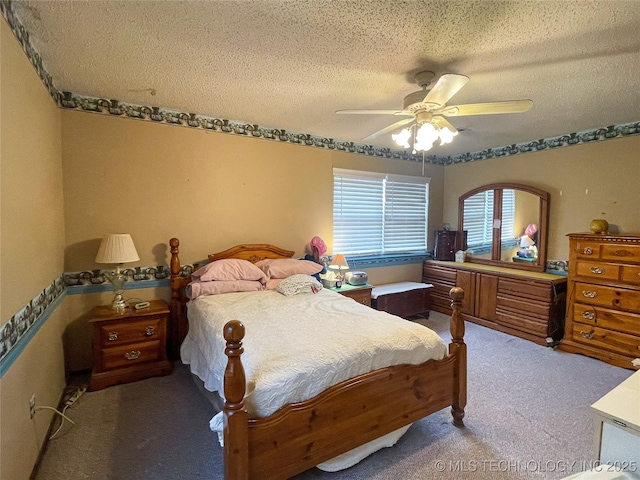 carpeted bedroom with a ceiling fan and a textured ceiling