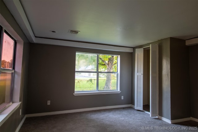 unfurnished bedroom featuring baseboards, visible vents, and carpet floors