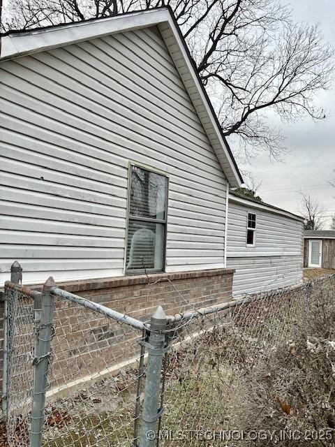 view of home's exterior with fence