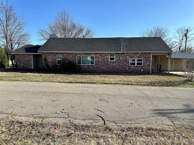 view of home's exterior with brick siding and a lawn