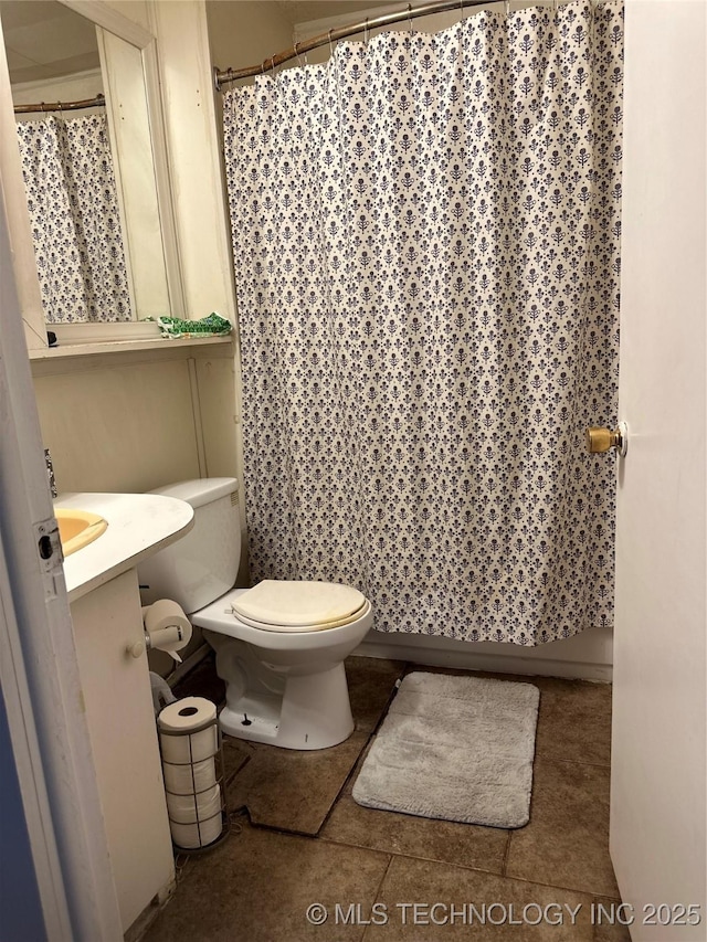 bathroom featuring tile patterned flooring, curtained shower, toilet, and vanity