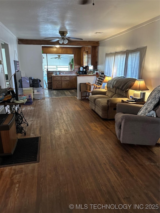 living room featuring dark wood-style flooring and ceiling fan