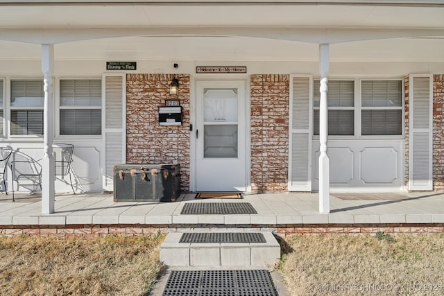 view of exterior entry featuring a porch