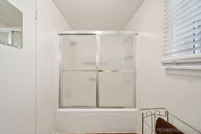 bathroom featuring shower / bath combination with glass door