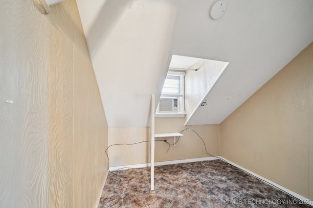 additional living space with lofted ceiling, cooling unit, carpet, and baseboards