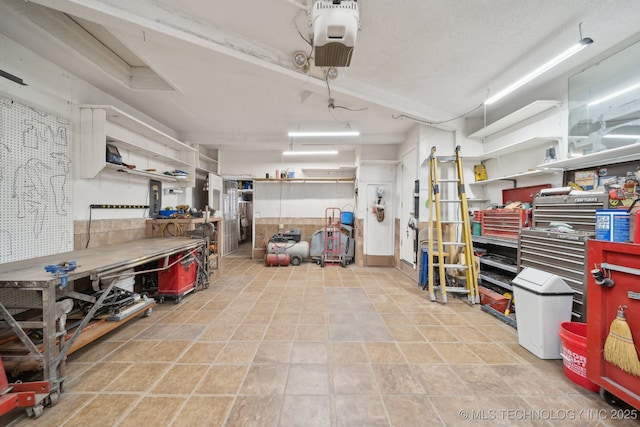 garage featuring a workshop area and a garage door opener