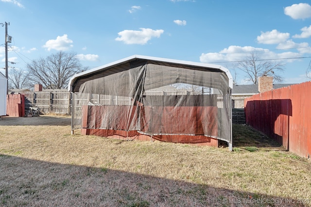 view of yard featuring an outdoor structure and fence