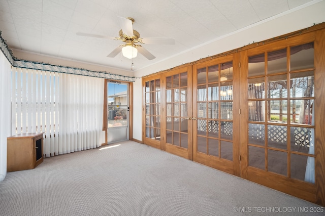 unfurnished sunroom with ceiling fan