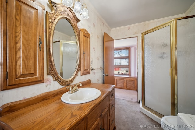 full bathroom featuring vanity, wallpapered walls, a stall shower, crown molding, and toilet