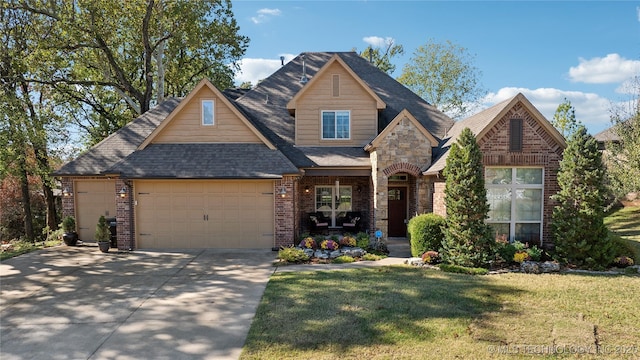 craftsman inspired home featuring driveway, an attached garage, a shingled roof, a front lawn, and brick siding