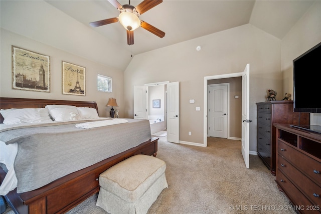 bedroom with light carpet, ensuite bathroom, baseboards, and vaulted ceiling