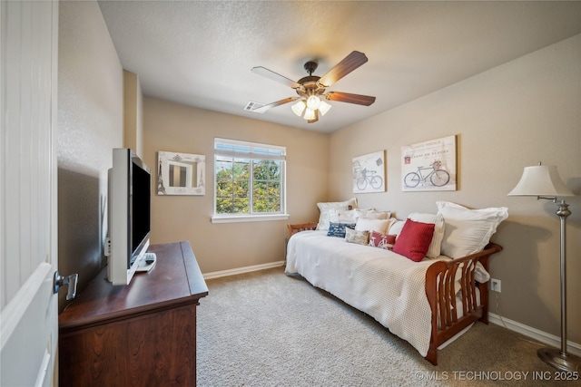 carpeted bedroom with visible vents, a ceiling fan, and baseboards