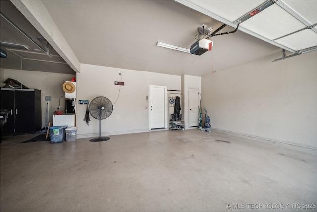 garage with baseboards and a garage door opener