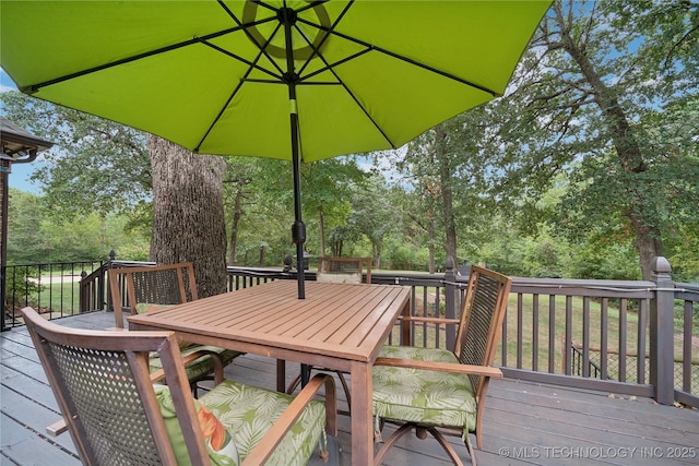 wooden terrace featuring outdoor dining space