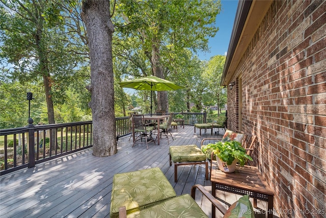 wooden terrace featuring outdoor dining space