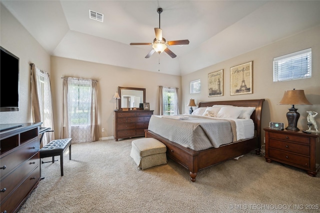 bedroom featuring a ceiling fan, visible vents, baseboards, vaulted ceiling, and light colored carpet