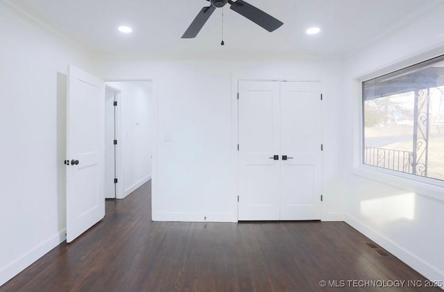 empty room with visible vents, recessed lighting, baseboards, and dark wood-style flooring