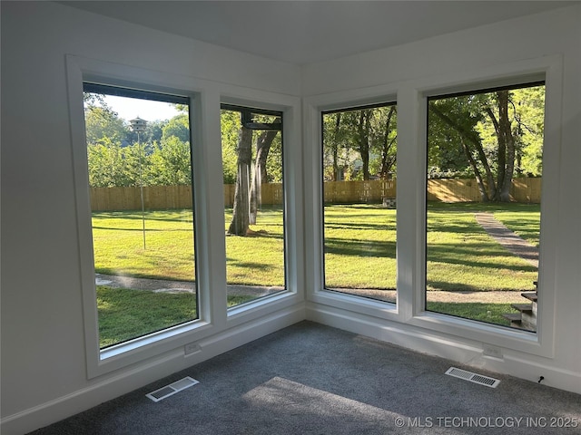 unfurnished sunroom featuring a wealth of natural light and visible vents