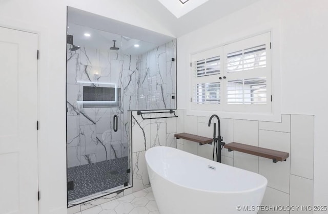 full bath with a marble finish shower, a soaking tub, recessed lighting, and tile walls