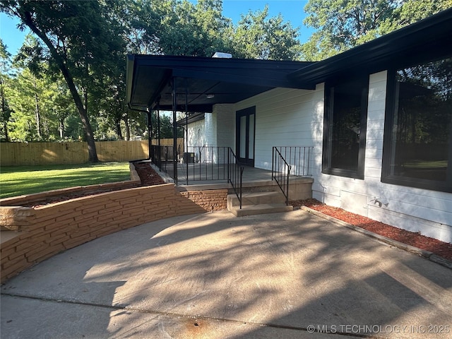 view of patio / terrace featuring fence and covered porch