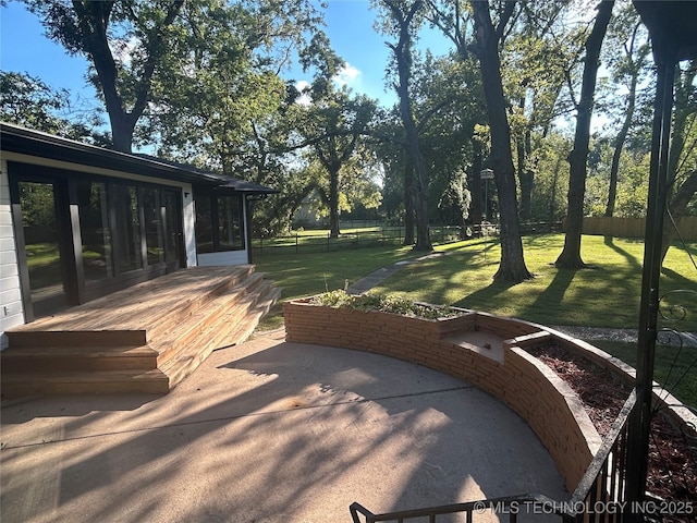 exterior space with a sunroom and fence