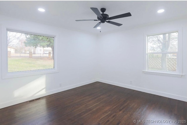 spare room featuring visible vents, baseboards, recessed lighting, dark wood-style floors, and a ceiling fan