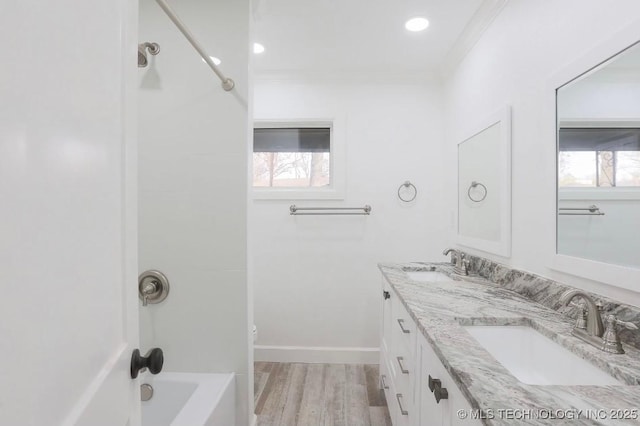 full bathroom featuring crown molding, plenty of natural light, and a sink