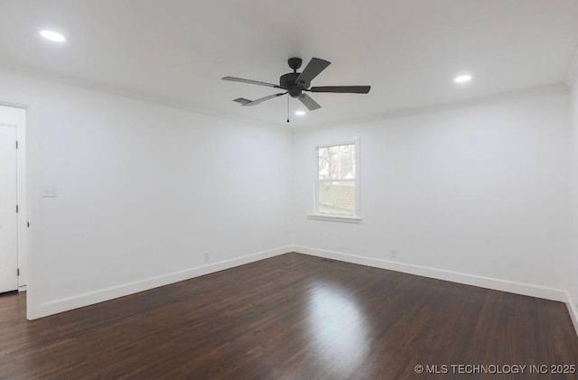 spare room featuring dark wood-type flooring and ornamental molding