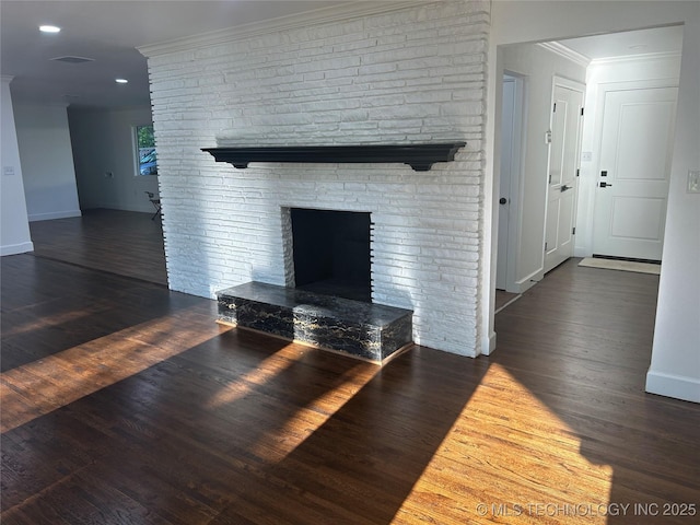 unfurnished living room with baseboards, ornamental molding, recessed lighting, a fireplace, and wood finished floors