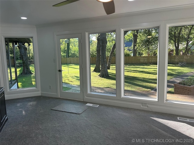 doorway to outside featuring recessed lighting, visible vents, and crown molding