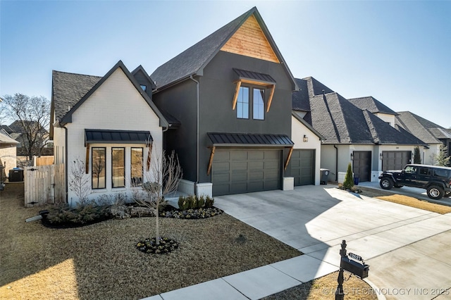 modern farmhouse style home with metal roof, a garage, concrete driveway, and a standing seam roof