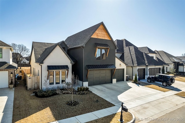 modern farmhouse featuring fence, concrete driveway, roof with shingles, stucco siding, and an attached garage