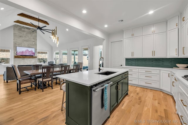 kitchen with a sink, white cabinetry, light wood-style floors, light countertops, and dishwasher