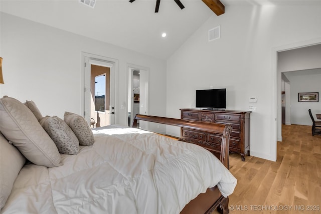 bedroom with visible vents, beamed ceiling, high vaulted ceiling, and light wood-type flooring