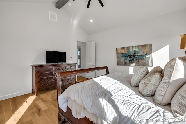 bedroom with visible vents, baseboards, beamed ceiling, light wood-style floors, and a ceiling fan