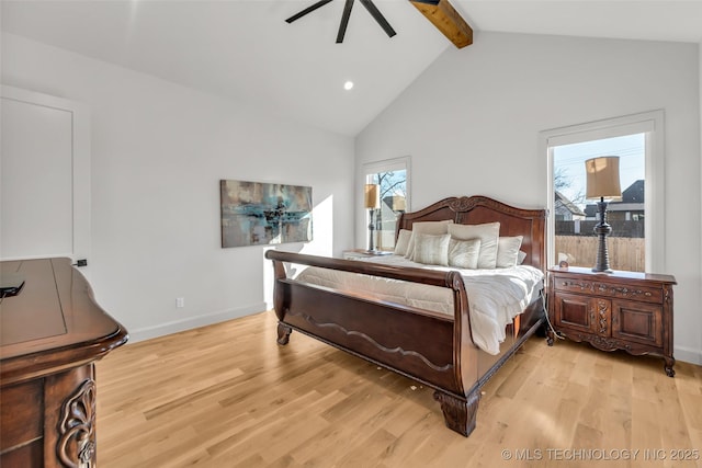 bedroom featuring beamed ceiling, multiple windows, and light wood-style floors