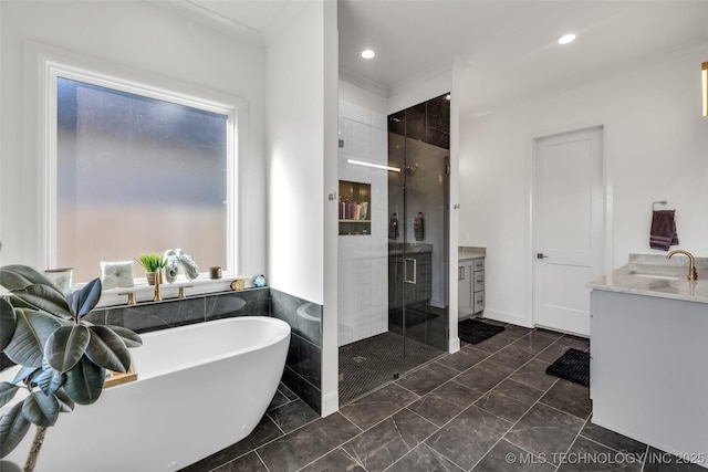 full bath featuring a soaking tub, recessed lighting, a stall shower, and vanity