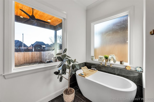 full bath with tile patterned floors and a soaking tub