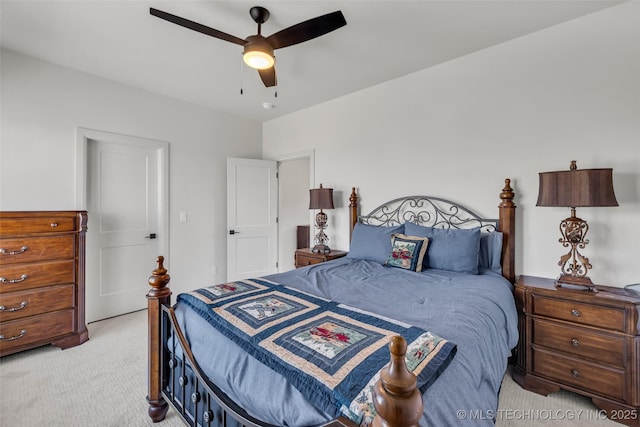 bedroom featuring ceiling fan and light carpet