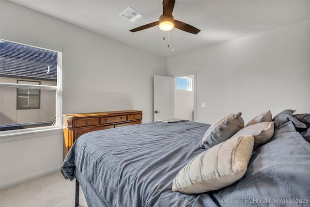 carpeted bedroom featuring baseboards, visible vents, and ceiling fan